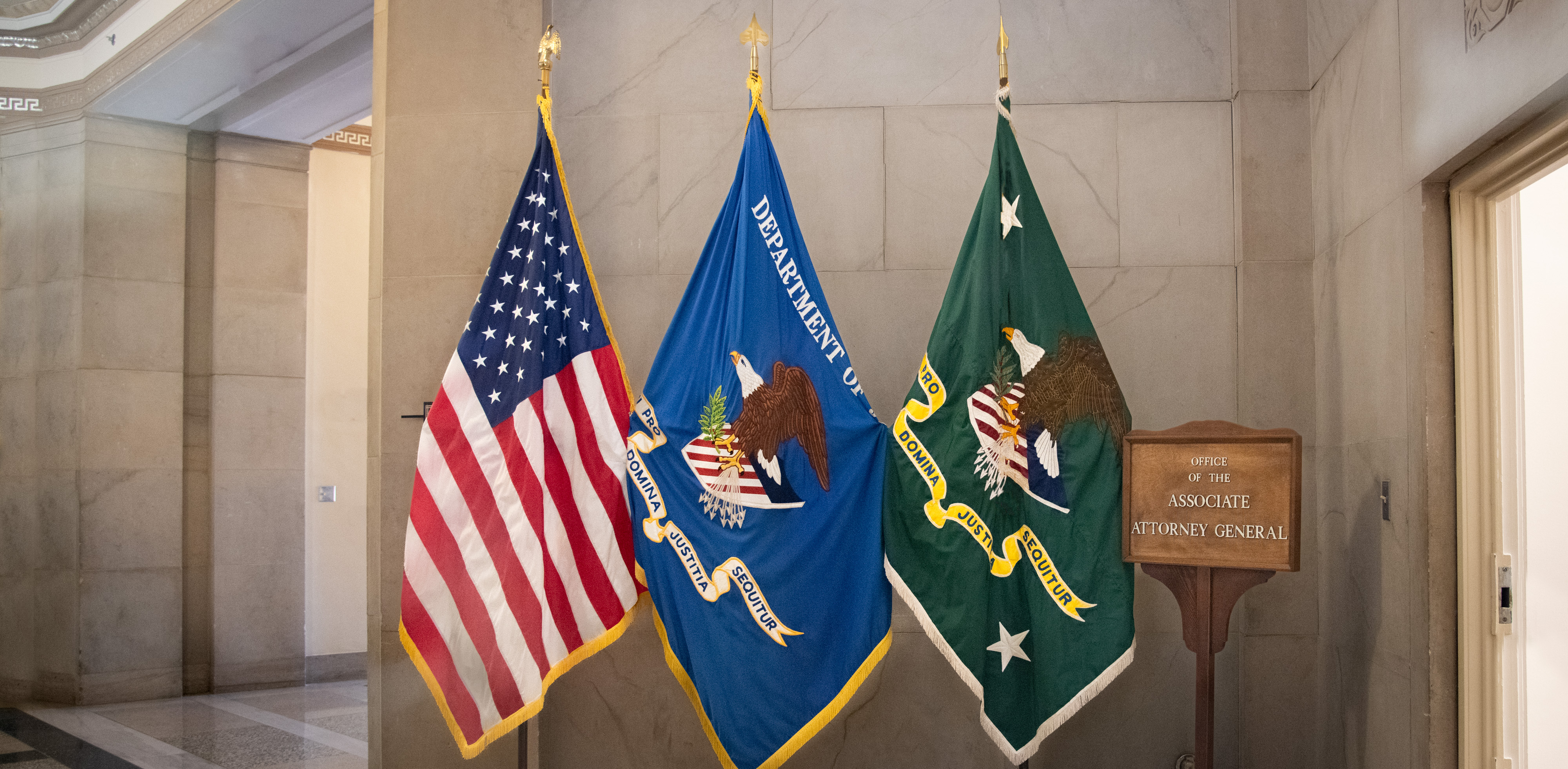 Flags outside the Office of the Associate Attorney General 