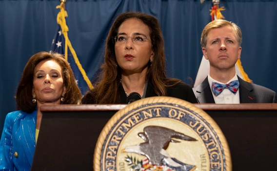 Assistant Attorney General Harmeet K. Dhillon delivers remarks from a podium at the U.S. Attorney’s Office for the District of Columbia. She is joined by federal and government officials.